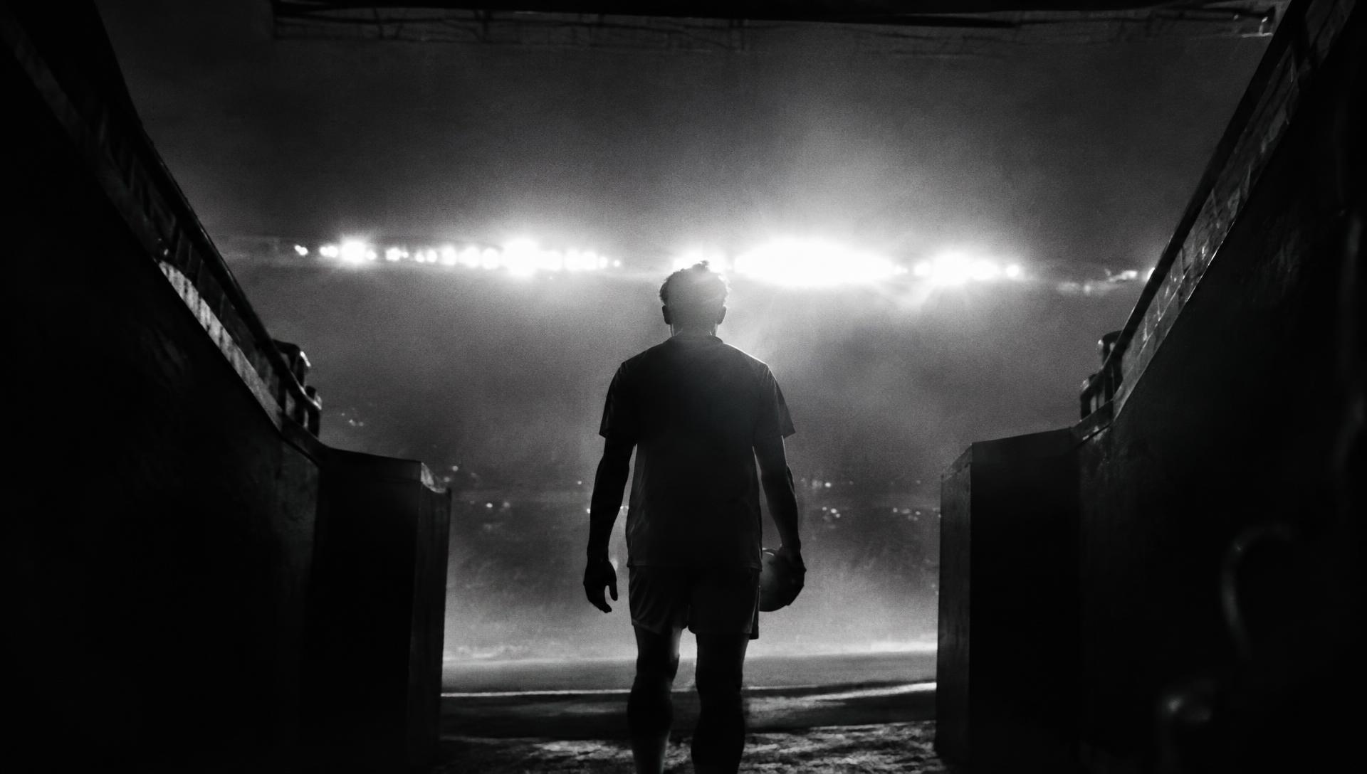 Athlete under stadium lights representing Dynasty Nation